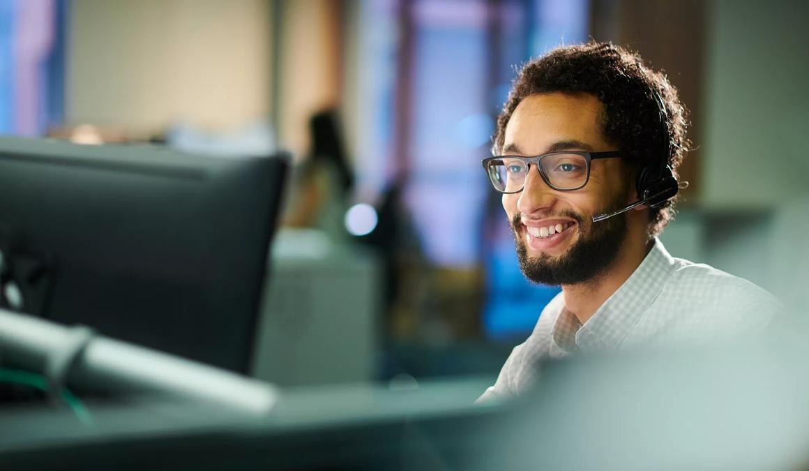 a male call center worker takes a call.